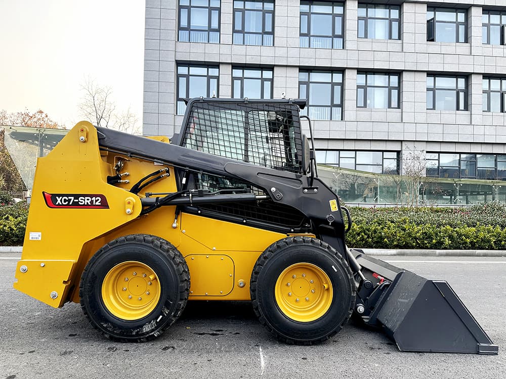 Yellow skid steer loader photographed in a supplier yard