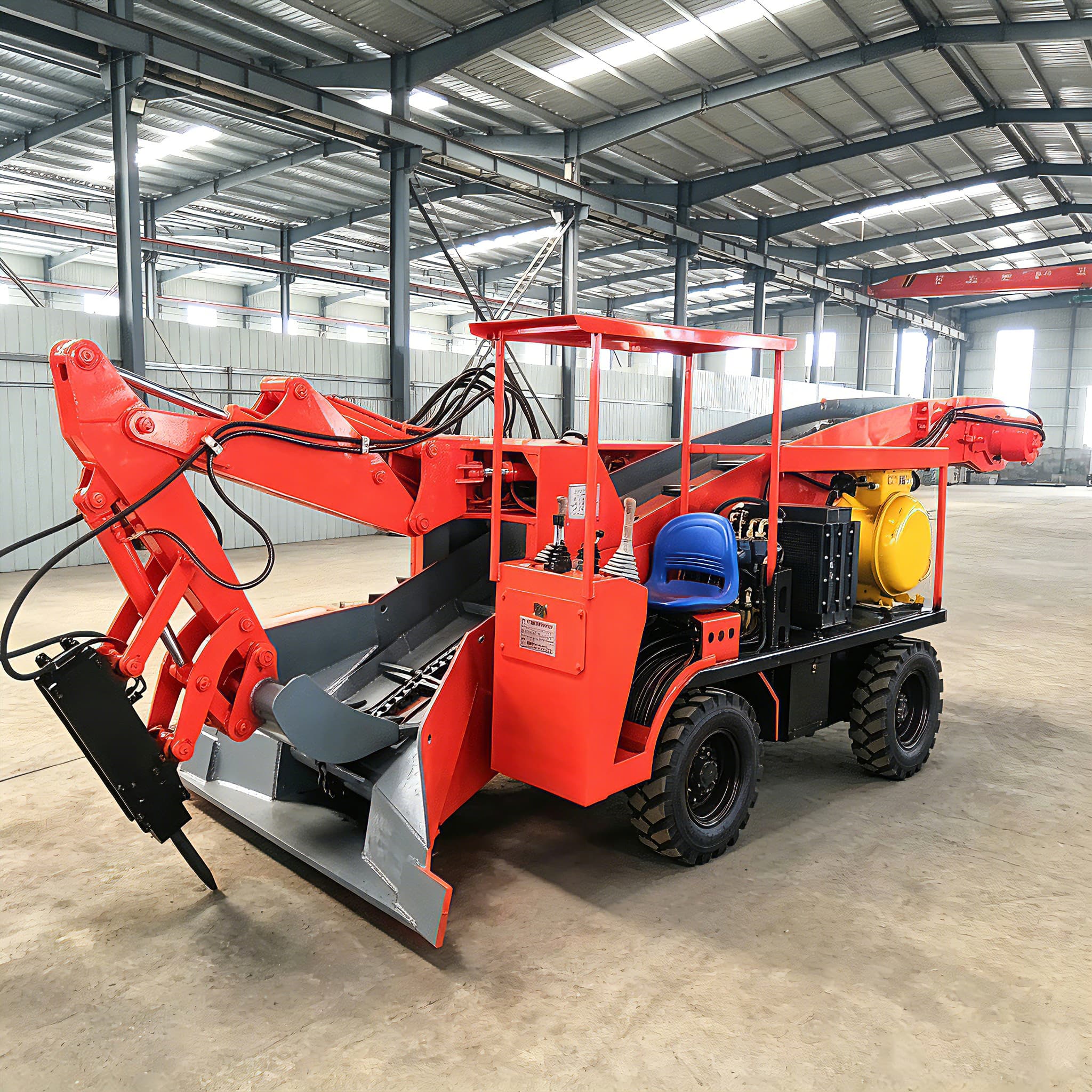 Wheeled mucking loader photographed in a workshop